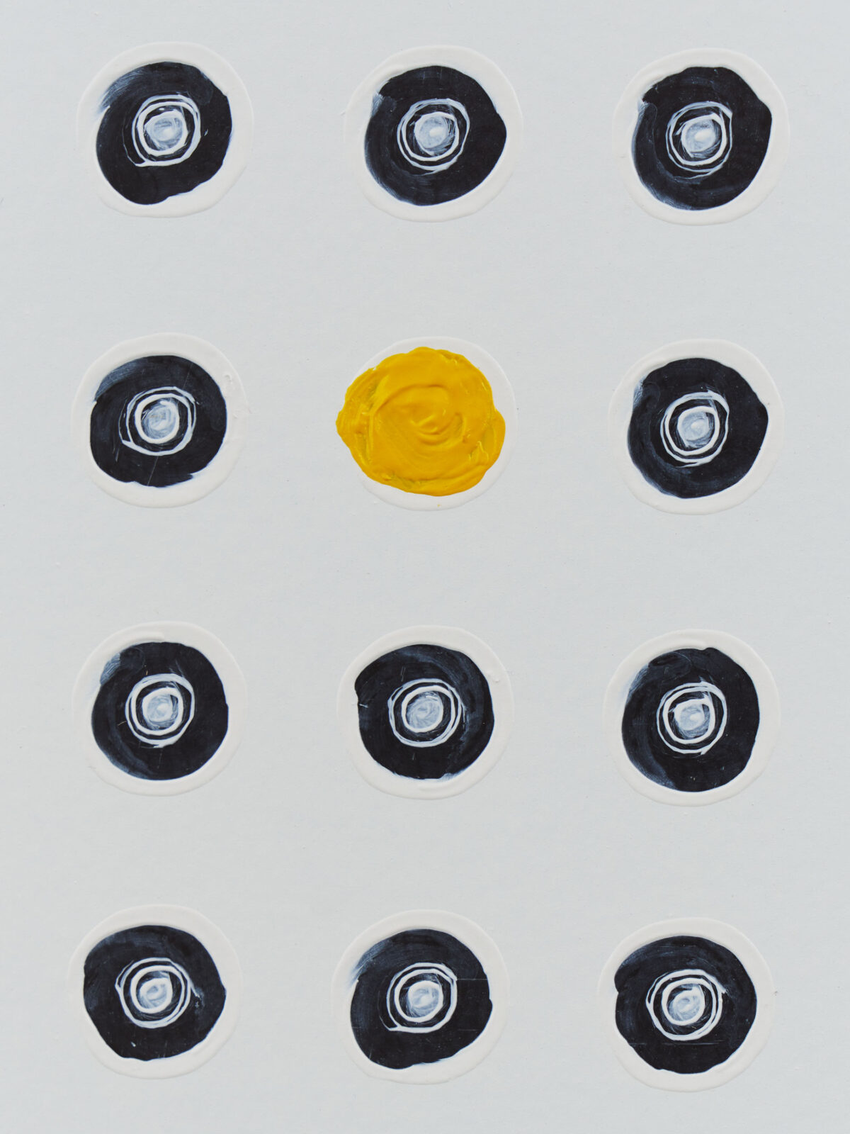 black repeating circles with one yellow circle
