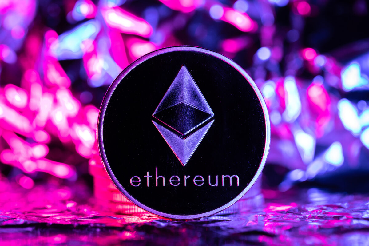 Ethereum cryptocurrency, physical coin in front of an abstract background