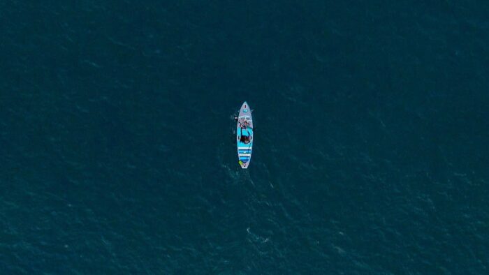 A drone photo of a surfer in open water