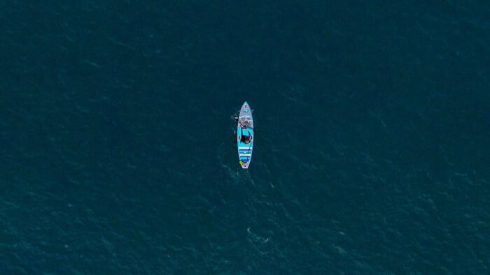 A Drone Photo Of A Surfer In Open Water